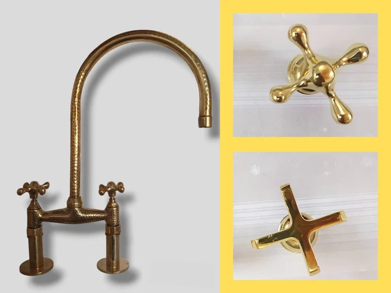 Set of brass kitchen faucet and handles on a gray background
