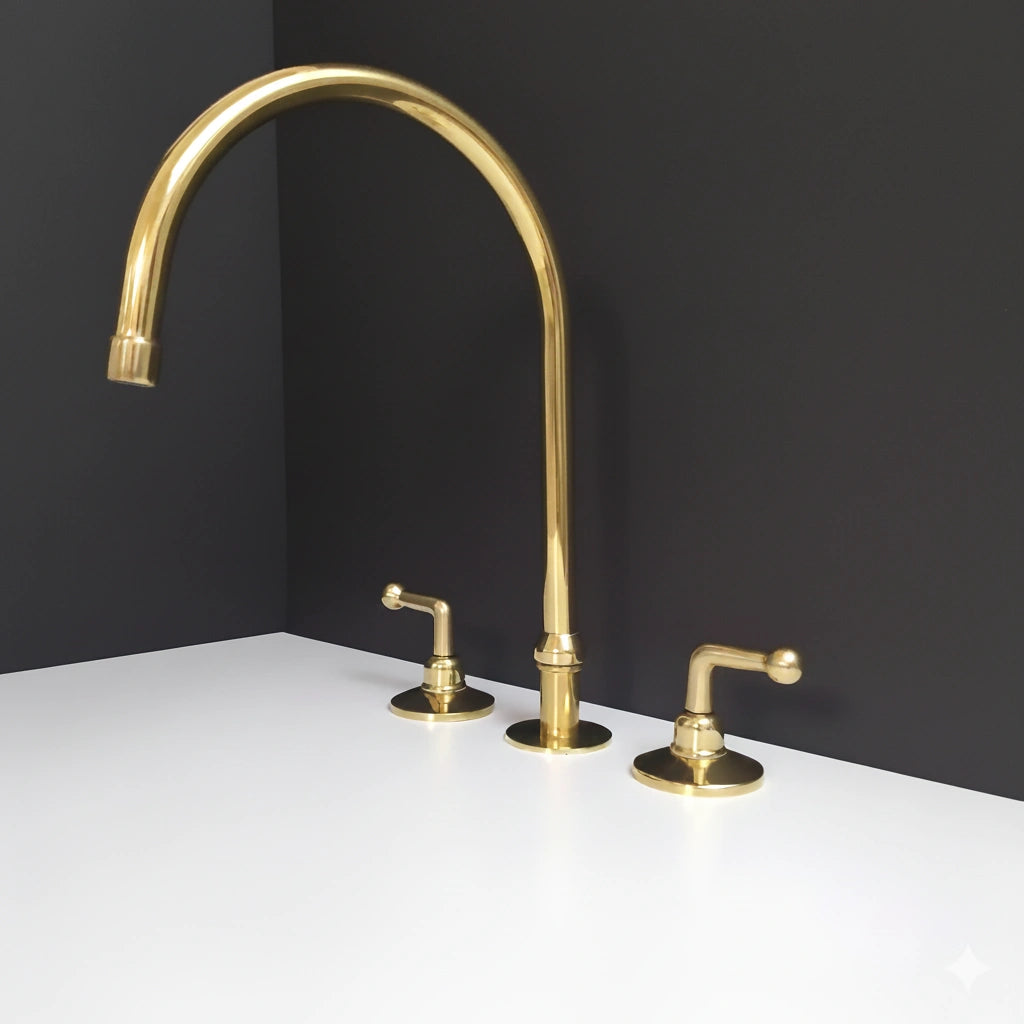 Gold kitchen faucet set on a white countertop with a black wall background