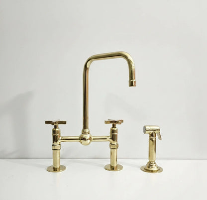 Gold kitchen faucet set on a white background